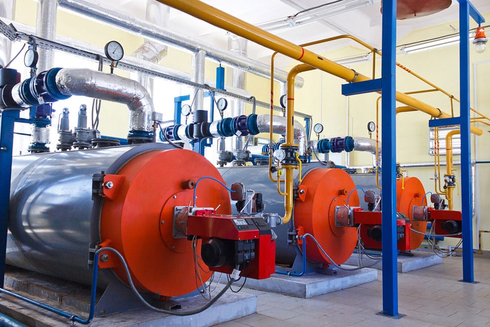 multiple large attached boilers in a room